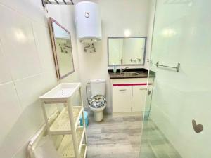 a small bathroom with a toilet and a sink at Cozy Bungalow in Costa Del Silencio