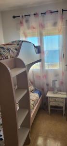 A bed or beds in a room at First Line Cabo Roig Orihuela Costa