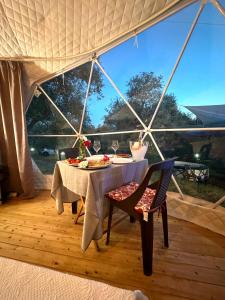 a dining table in a tent with a table and chairs at Glamping Domes San Martino in Itri