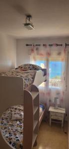 A bed or beds in a room at First Line Cabo Roig Orihuela Costa