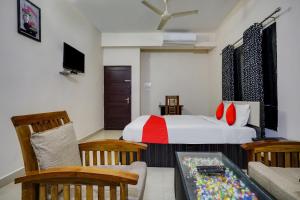 a bedroom with a bed and a living room at OYO Flagship Arrows Tourist Home in Cochin