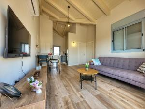 a living room with a couch and a table at ניצן בגולן in Yonatan