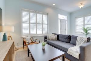 a living room with a couch and a table at Amazing 1 BR Apartment 5 min from Waterfront Park in Alexandria