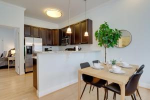 a kitchen and dining room with a table and chairs at Amazing 1 BR Apartment 5 min from Waterfront Park in Alexandria