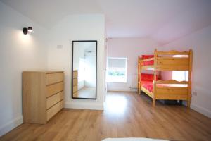 a bedroom with two bunk beds and a mirror at Rock House Sligo in Riverstown