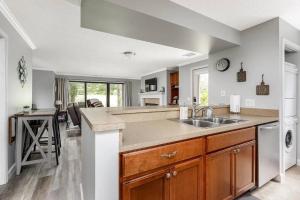 a kitchen with a sink and a counter at Modern Golfview Condo near the Grand Traverse Bay in Williamsburg