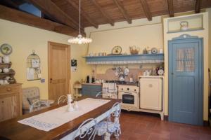 a kitchen with a stove and a table in a room at Casetta dei lagoni in Arona