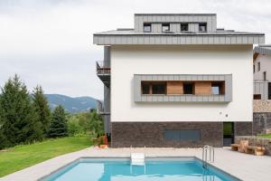 a house with a swimming pool next to a building at my Vista by Mountain ways in Rokytnice nad Jizerou