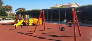 a playground with a slide and swings at Casa Mateus - Colares, Parque Natural Sintra Cascais in Sintra