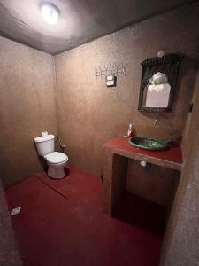 a small bathroom with a toilet and a sink at Dar Talmoudi in Tagounite