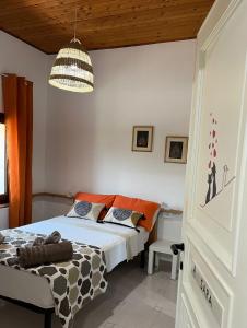 a bedroom with a bed and a chandelier at Le Sorgenti Guest House in Ilbono