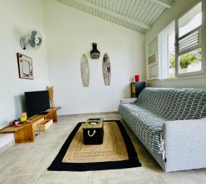 a living room with a couch and a table at Appart au Helleux in Sainte-Anne