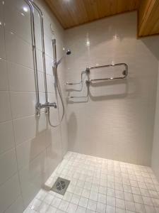 a bathroom with a shower and a tiled floor at Arctic Escape in Rovaniemi