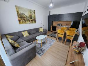 a living room with a couch and a table at Apartment Sweet 21 in Tirana