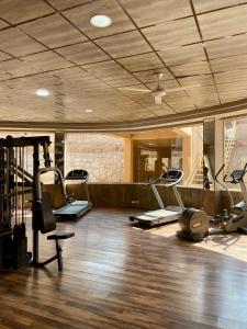 a gym with several treadmills and elliptical machines at Apartment in el karma aqua beach resort hurghada near El gouna in Hurghada +38 photos