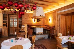 a dining room with two tables and a stove at Chalet del Capriolo in Vodo Cadore