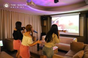 three girls playing a video game on the wii at The South-Dawn in Hengchun