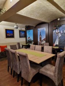 a dining room with a wooden table and chairs at Galeona - Hotel turystyczny in Elblag