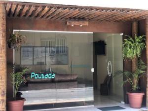 a glass storefront with a couch in the window at Fabika Pousada in Maragogi