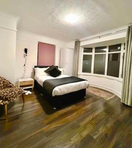 a bedroom with a bed and a chair in it at City Signature Apartments in Cambridge