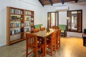 a dining room with a table and chairs and bookshelves at Waya Island Resort in Yalombi