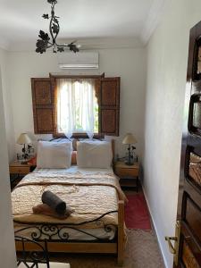 Ένα ή περισσότερα κρεβάτια σε δωμάτιο στο Appartement dans résidence avec piscine