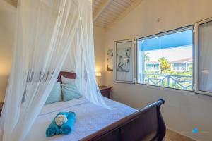 a bedroom with a bed and a large window at Marina view apartments in Kralendijk