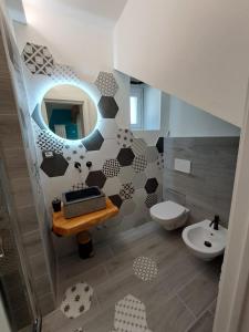 a bathroom with a toilet and a sink and a mirror at Stone House in San Maurizio dʼOpaglio