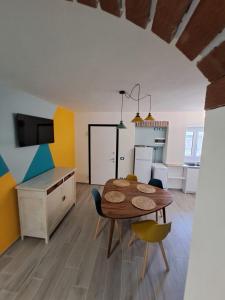 a kitchen and dining room with a table and chairs at Stone House in San Maurizio dʼOpaglio