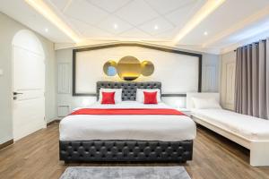 a bedroom with a large bed with red pillows at Luxury Villa Belvedere Bali in Seminiak in Legian