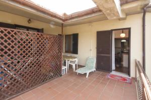 a room with a patio with a wall of wine bottles at Agriturismo La Gazzella in Cura Nuova