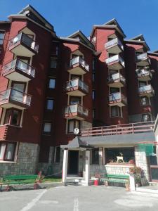 a large red building with balconies on it at Appartamento in Bella Vista ai Piedi del Cervino in Breuil-Cervinia