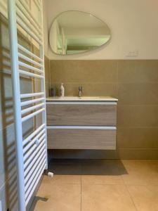 a bathroom with a sink and a mirror at Gîte du Florival in Lautenbachzell