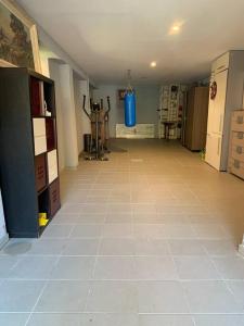 an empty room with a large tile floor in a building at Gîte du Florival in Lautenbachzell