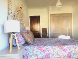 a bedroom with a bed and a lamp on a table at Alojamento Santa Helena in A dos Cunhados