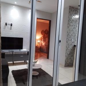 a sliding glass door leading into a room with a desk at Flat Turmilagres Bontempo in São Miguel dos Milagres