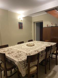 a dining room table with chairs and a white table cloth at Casa Mamu en microcentro in Resistencia