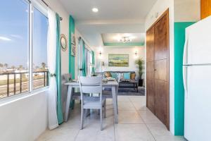 a dining room with a table and a view of the ocean at Bright Chick Condo 19 Gardenhaus in Tijuana