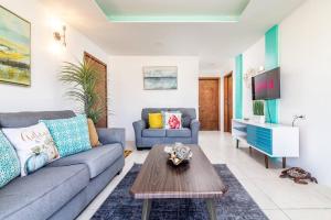 a living room with a couch and a table at Bright Chick Condo 19 Gardenhaus in Tijuana