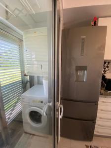 una cocina con nevera y lavadora en Apartamento Raposo, en São Roque 31 fotos más