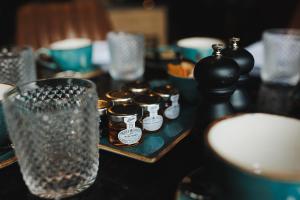 a table with jars and glasses on a table at Caer Rhun Hall Hotel in Conwy