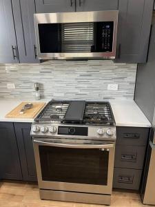 a kitchen with a stove and a microwave at The Silver Benz in Atlanta