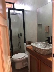 a bathroom with a sink and a toilet at Casa Natural in Los Órganos