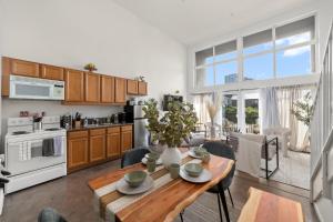 a kitchen and living room with a table and chairs at The Italian Retreat, Little Italy in San Diego