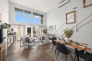 a dining room and living room with a table and chairs at The Italian Retreat, Little Italy in San Diego