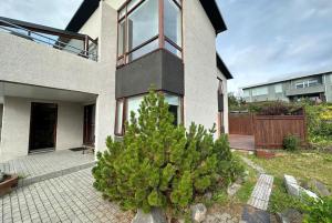 a house with a christmas tree in front of it at Spacious Family friendly house in the Reykjavik in Reykjavík