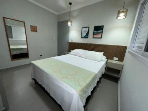 Un pat sau paturi într-o cameră la Pousada Praia Grande