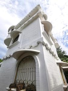 a white building with a large gate at Mitico El Castillo in Palenque