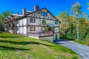a large house on a hill with a driveway at Alpine Condo #A5 in Brian Head