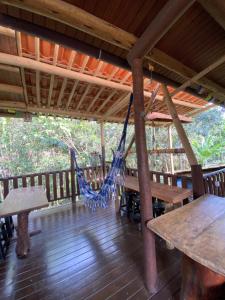 a hammock on the porch of a cabin at Pousada Natureza Viva in Itacaré